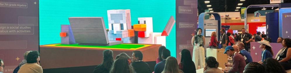 A large screen displays an action video gameplay for viewers.