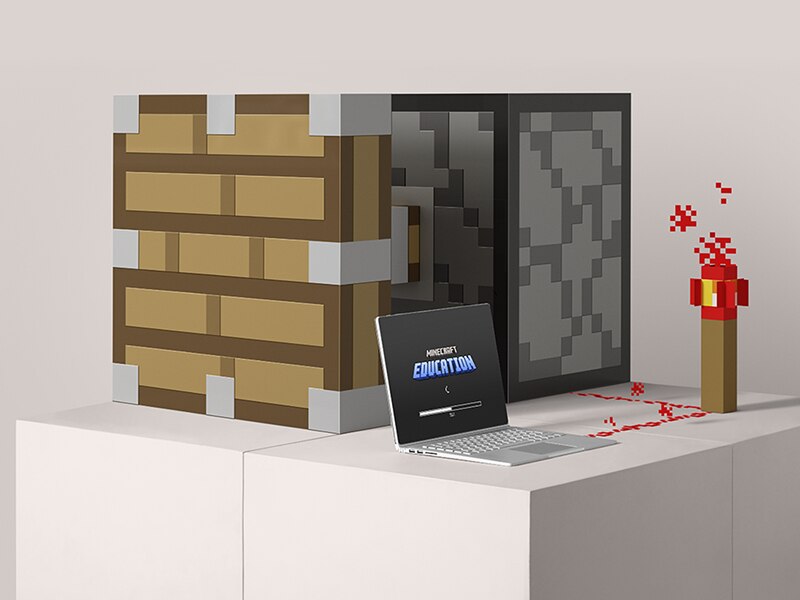 A laptop showing the Minecraft Education loading screen is connected through redstone to a pressure plate mechanism.