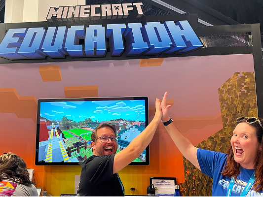 Educators high-fiving at a Minecraft Education booth