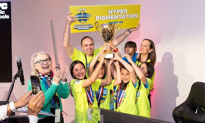 Group of kids holding up a trophy