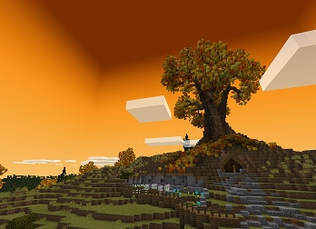 A Pixelated landscape in a Minecraft game, featuring a large tree with autumn leaves under a vivid orange sky.